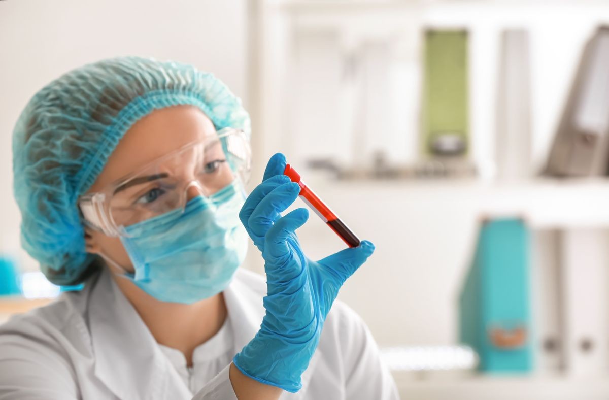 Woman working with blood sample in laboratory