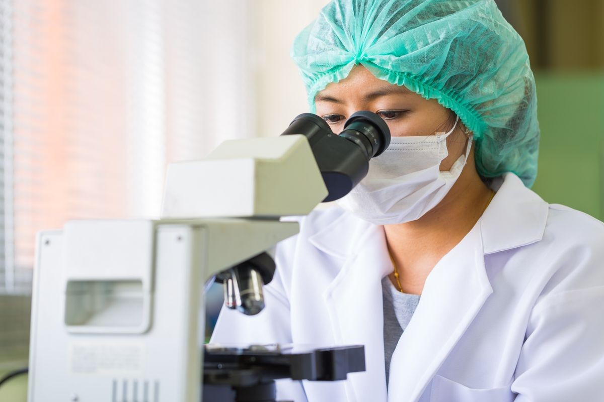 Scientist using a microscope in a laboratory